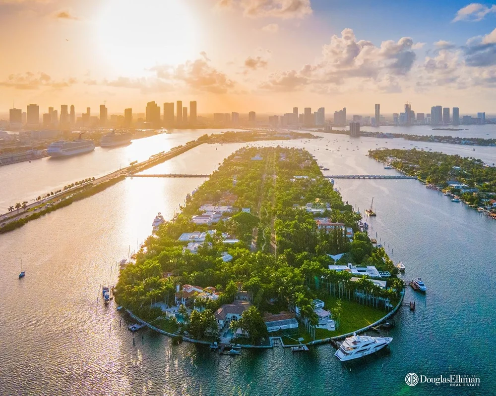 Aerial view of Palm Island waterfront homes in South Beach 33139 at sunset with Miami skyline