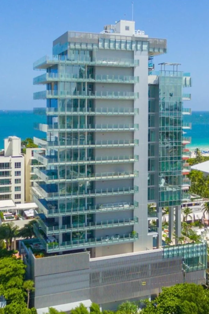 The modern, all-glass facade of Glass South Beach, an exclusive boutique luxury condominium at 120 Ocean Drive in Miami Beach's prestigious South of Fifth neighborhood.