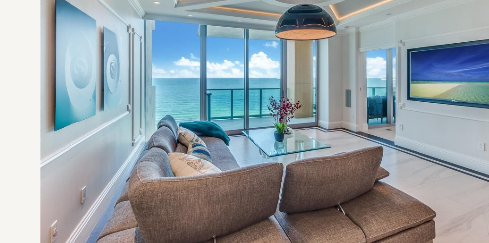 Interior of Miami Beach luxury condo for sale with floor-to-ceiling ocean view windows and high-end finishes