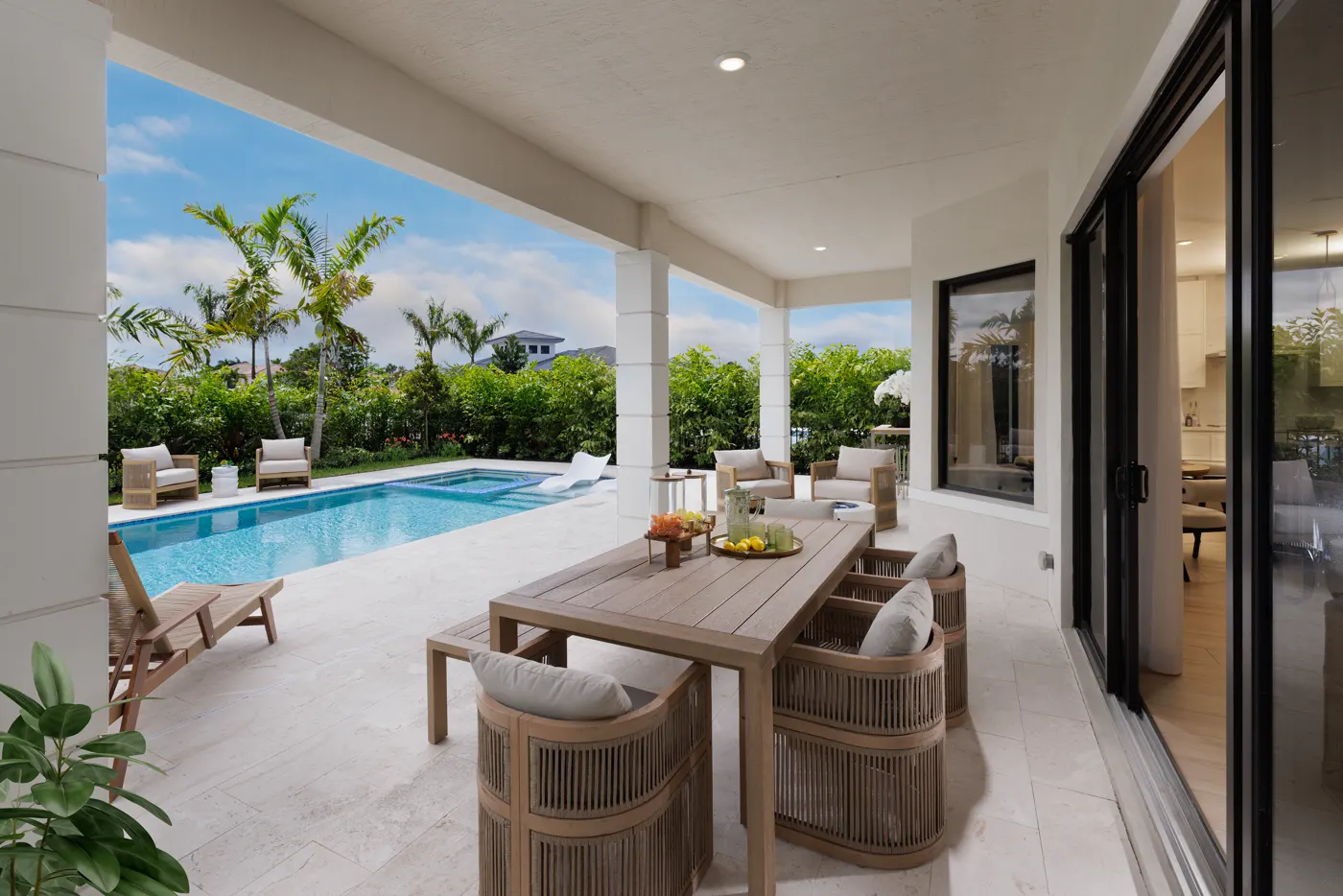 Covered patio and outdoor dining beside the pool at the Piedra model, Greenview at Presidential