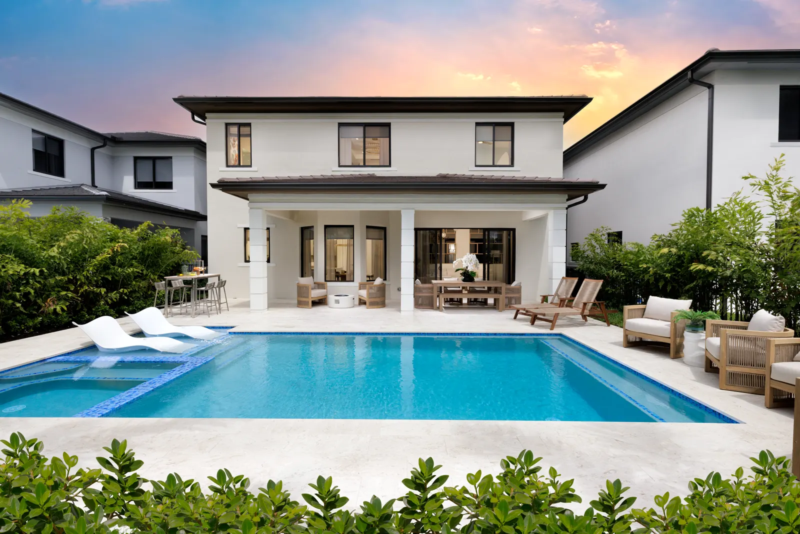 Private pool and spa at sunset behind the Piedra model home at Greenview at Presidential