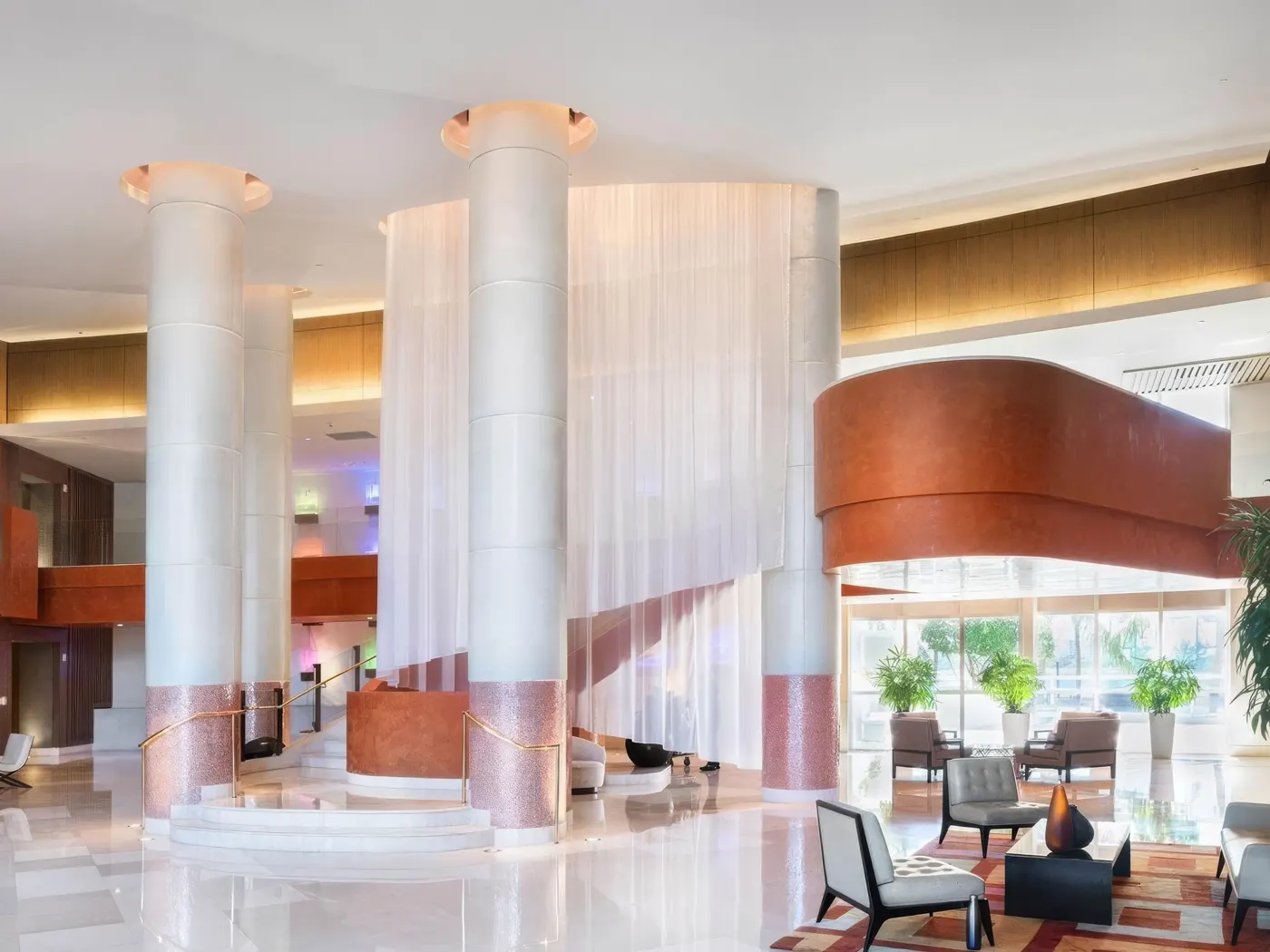 Murano Grande double-height lobby with sheer drapery around its columns and lounge seating