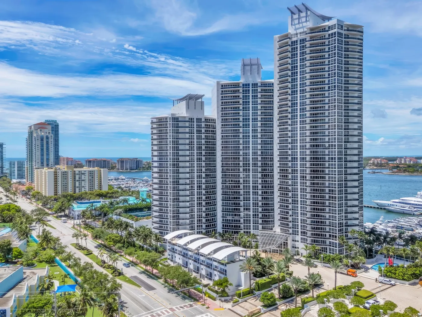 Murano Grande three stepped towers and townhouses seen from above Alton Road, with the Miami Beach Marina at right