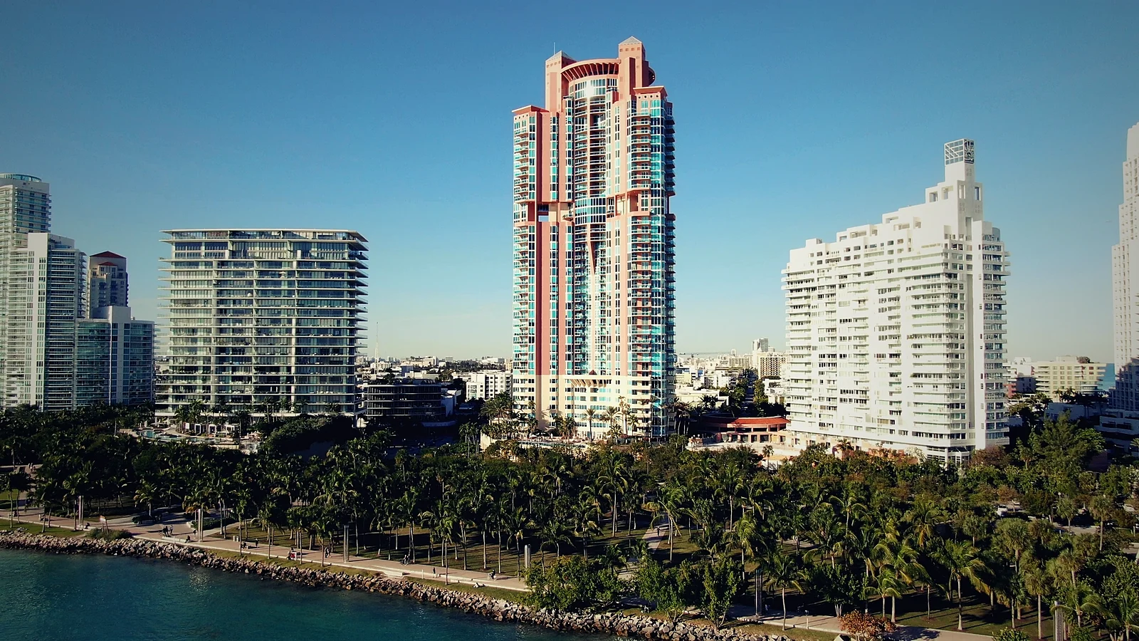 Portofino Tower condo tower at 300 South Pointe Drive rising above the palms of South Pointe Park, Miami Beach