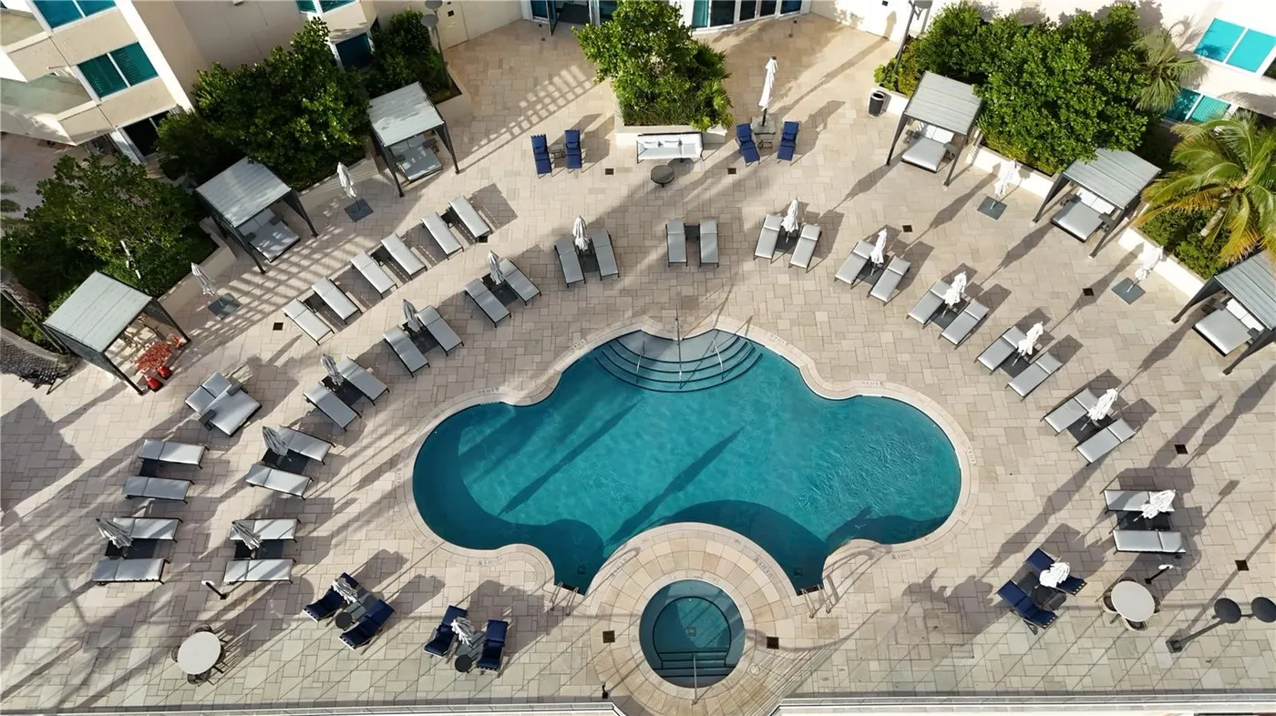Portofino Tower pool deck from above, with a free-form pool, a spa, loungers and cabanas