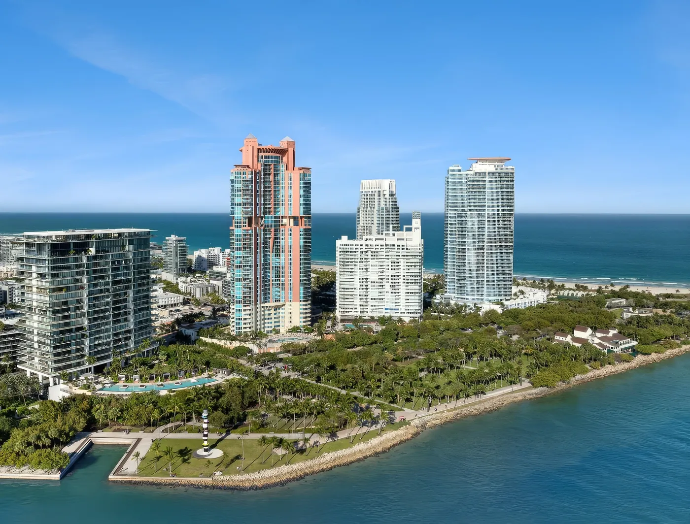 Portofino Tower rising behind South Pointe Park and the Government Cut seawall, with the Atlantic Ocean beyond